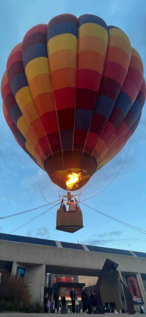 And up it goes. Hot air balloon hovers over Hagis Mall at UMass Amherst.